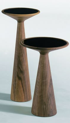 two wooden pedestals sitting on top of each other in front of a white background