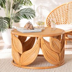 a wicker coffee table sitting on top of a rug next to a chair and potted plant