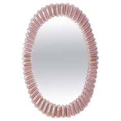 a round pink beaded mirror on a white background