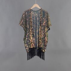 Welcome to my shop, I am in China. It will need around 30 days for international orders. Please consider the time when placing order. Sequin bohemian kimono,perfect for a casual day out. Material: mesh, sequins Body width available S: 27.5 inches(70cm), circle 55 inches(150cm) M: 31.5 inches(80cm), circle 63 inches(160cm) L: 35.5 inches(90cm), circle 71 inches(180cm) Body length available Short:33.5 inches (85cm) include tassels Long: 43.3 inches (110cm) include tassels CARE: Wash gently by hand in cold water.  Single wash. Don't press! Hang to dry.  Maybe you will like other items in my shop, find them here: https://www.etsy.com/shop/twogirlstudio Bohemian Open Front Kimono For Party, Black Summer Party Kimono, Black Kimono With Kimono Sleeves For Party, Bohemian Kimono For Summer Party, Bohemian Summer Party Kimono, Summer Party Bohemian Kimono, Bohemian Spring Party Kimono, Spring Party Kimono With Open Front, Spring Party Open Front Kimono