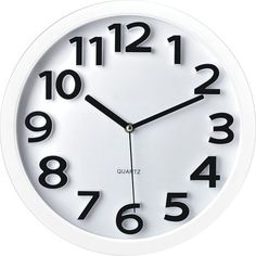 a white wall clock with black numbers on the front and back of it's face