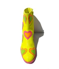 These adorable ankle boots are crafted in a neon yellow leatherette and feature rainbow patent leatherette hearts throughout. Complete with side zipper and 2 inch heels.Please note these shoes have a 2-3 day handling time before they will ship from our warehouse and there is a 10% restocking fee if you choose to return. Funky Shoes Macy's, Vivid Color Shoes, La Moda Boots Hearts, Power Puff Boots, I Love Lucy Shoes, Dopamine Dressing Shoes, Comedian Headshots, Hoedown Outfit, Toola Roola