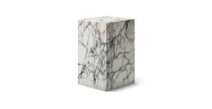 a white and black marble block on a white background