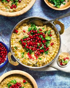 two bowls filled with soup and garnished with pomegranates