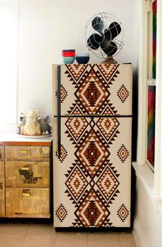 an old fashioned refrigerator is decorated with native designs