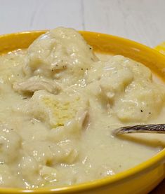 a yellow bowl filled with meat and gravy