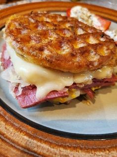 a sandwich with meat and cheese on a plate