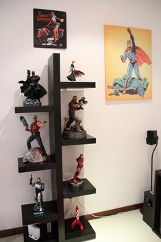 the shelves are filled with figurines and action figures, including one being superman