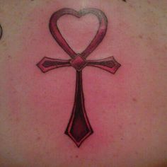 a cross tattoo with a heart on it