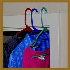 clothes hanging on hooks in front of a door