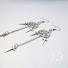 These dark and alluring Dagger Earrings. Measuring 3.5 inches in length, these alloyed earrings are perfect for adding a touch of edgy style to any outfit. Make a statement and stand out from the crowd with this must-have accessory. Hypoallergenic Punk Dangle Earrings, Hypoallergenic Dangle Earrings In Punk Style, Edgy Pierced Metal Earrings, Punk Hypoallergenic Dangle Jewelry, Alternative Style Dangle Earrings For Gift, Hypoallergenic Punk Dangle Jewelry, Edgy Silver Metal Plug Earrings, Edgy Metal Plug Earrings, Edgy Metal Earrings With Ear Wire