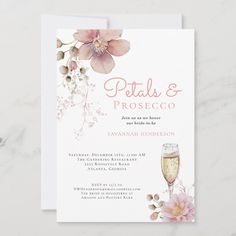 a wedding card with pink flowers and wine glasses on the front, which reads petals & prosceco