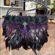 This Is A One Of A Kind Lcj Handbag Custom-Made For A Special Soire. It Is A Vintage Faux/ Suede Handbag (10 1/2x 5 1/2) That Was Embellished With Exquisite Raven Plumage And Jeweled Cross. There A Few Thick Purple Accent Feathers In The Front, That Give The Bag Dimension And Extra Thickness (About 2” At Top When Clasp Is Closed And 3” At Bottom) And Depth. Bag Measures Several Inches Longer Than Original Bare Vintage Bag, Because Of The Long Feathers In Center Front. It Is Exquisite And So Uniq Luxury Purple Pouch Bag, Luxury Purple Clutch Shoulder Bag, Luxury Purple Evening Satchel, Purple Detachable Handle Crossbody Shoulder Bag, Purple Crossbody Shoulder Bag With Detachable Handle, Purple Handheld Shoulder Bag With Top Carry Handle, Purple Rectangular Bag With Dust Bag, Purple Crossbody Evening Bags, Purple Shoulder Bag With Detachable Handle For Evening