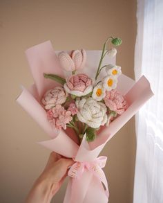 a person holding a bouquet of flowers in their hand