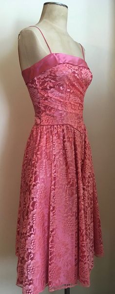 "Beautifully feminine pink lace & satin party dress with basque waist and ruching is a custom made creation from the 1980's. Dress has spaghetti straps, zips up in the back and is lined in satin. Dress is in excellent condition. Chest 32\"-34\" Waist 26\" Hips 44\" plus Length from armpit to hem 35\" All vintage is sold in \"as-is\" condition. We do our best to inspect, correct, and list important flaws. All measurements are made with the garment laying flat. Length is measured from shoulder Strapless Lace Dress For Prom Season, Pink Dress With Lace Bodice And Spaghetti Straps, Pink Spaghetti Strap Dress With Lace Bodice, Party Lace Dress With Lined Bodice, Pink Lace Dress With Spaghetti Straps, Vintage Lace Dress With Spaghetti Straps, Pink Lace Dress With Fitted Bodice, Pink Fitted Lace Dress For Formal Occasions, Pink Lace Dress With Lace Bodice