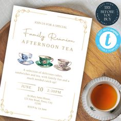 an afternoon tea party is set up on a wooden tray next to a cup of tea