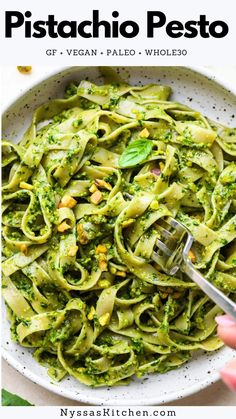 a white bowl filled with pasta and pesto sauce