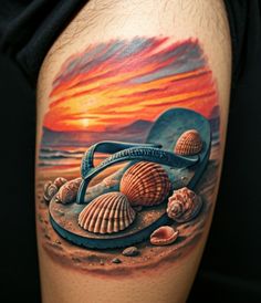 a man's thigh with seashells and shells on the beach at sunset