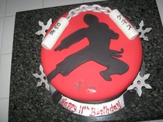 a red and black birthday cake sitting on top of a counter