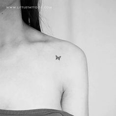 a black and white photo of a woman with a butterfly tattoo on her back shoulder