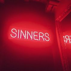 a red neon sign that says sinners on it