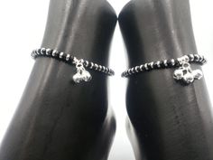 "Description 925 Sterling Silver Stretchable Black Bead Anklet (92.5% Silver purity) available in four to five lengths from from 4.5 inch (0-12 month) ,5.5 inch (1-3 Years) 6.5 inch (4-9 Years) & 7.5 inch (10-12 Years)and suitable for daily use. Makes low bell / charms sound \"chann-chann-chann\", weaved with NYLON Flexible elastic WIRES and stretchable . SOLD IN PAIRS. Dimensions Anklet Weight: ~11.0-16.0 grams / pair. 1 Pair 4.5-inch + 0.5 inch (nylon stretchable Extension) Anklet: ~11.0-1 Black Anklets With Round Beads For Gift, Black Thread Anklet Silver, Cheap Adjustable Black Beaded Anklets, Silver Black Beads Anklets, Black Adjustable Anklets For Beach, Bell Sound, Beautiful Anklet, Beaded Anklets, Nose Stud