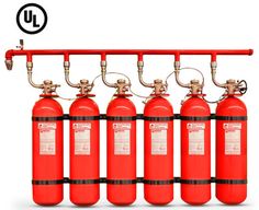 red fire extinguishers are lined up against a white background with the words uj above them