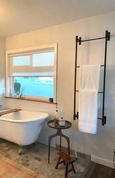 a white bath tub sitting next to a window