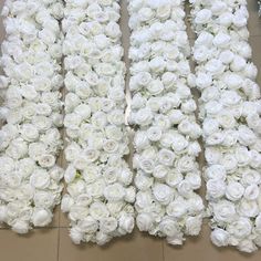 three rows of white roses laid out on the floor