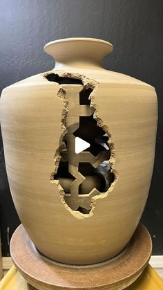 a vase that has been cut open and is sitting on a table with other items around it