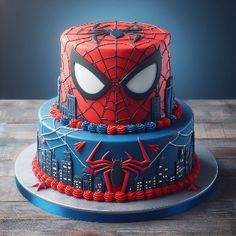 a spiderman birthday cake on a wooden table