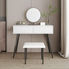 a white dressing table with mirror and stool