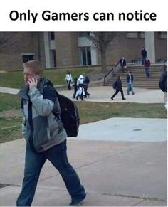 a man talking on a cell phone while walking down a sidewalk in front of a building