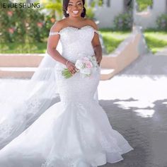 a woman in a wedding dress posing for the camera