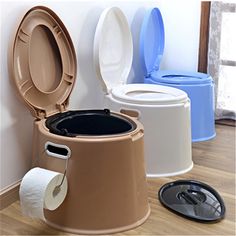 there are many different types of toilets in this room together, including one with the lid open