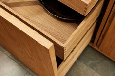 a pan is sitting on top of a wooden drawer