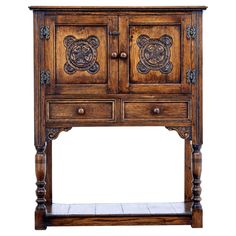 an old wooden cabinet with carvings on the doors and drawers, isolated against a white background