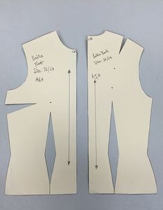 two pieces of paper cut out to look like dresses