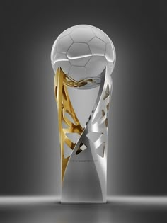 a white and gold soccer trophy on a gray background