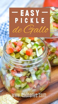 two glass jars filled with pickle and cucumber salad on top of a wooden cutting board