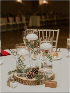 candles and pine cones are sitting on a table