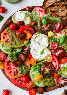 a salad with tomatoes, broccoli, cucumbers and other toppings