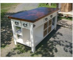 a kitchen island made out of an old table with drawers on the top and bottom