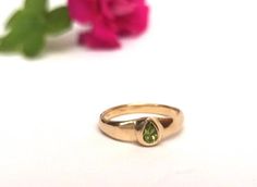 Beautiful and unique solid gold ring signet ring set with pear-shaped peridot, alternative engagement or wedding ring. This wide 14K yellow gold ring is set with a pear-shaped light green peridot. The ring's wide design and the color of the peridot give this ring a certain air of majestic and quiet confidence.This ring is comfortable and noticeable and will be great for everyday use, as for a special occasion. It can also be a modern engagement ring.This ring will be a perfect gift for a strong Yellow Gold Teardrop May Birthstone Ring, Yellow Gold Teardrop Ring For May Birthstone, Yellow Gold Teardrop Ring With Birthstone, Yellow Gold Pear Solitaire Ring, Pear-shaped Rings With Tension Setting For Gift, Pear Shaped Bezel Setting Wedding Rings, Pear-shaped Bezel Set Wedding Ring, Gold Teardrop Emerald Promise Ring, 14k Yellow Gold Pear-shaped Ring