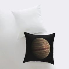 a pillow that has a picture of the planet on it and is in front of a white wall