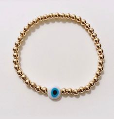 This listing is for a 14k gold filled beaded bracelet with an 8mm flat white And blue evil eye. Made to order please allow 1-2 weeks for delivery. Leave wrist size at checkout. Gold Evil Eye Bracelet For Everyday, Gold Spiritual Evil Eye Bracelet For Everyday, Gold Evil Eye Bracelet With Spacer Beads, Gold Evil Eye Bracelet With Round Spacer Beads, Adjustable Gold Evil Eye Bracelet For Everyday, Gold Spiritual Evil Eye Bracelet Hand-strung, Adjustable Gold Evil Eye Bracelet With 8mm Beads, Gold Evil Eye Bracelet With 8mm Beads For Gifts, Gold Evil Eye Bracelet With 8mm Beads As Gift