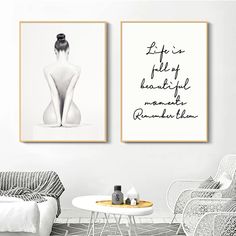 two framed art prints on the wall above a white table and chairs in a living room