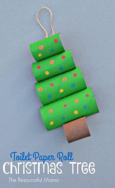 the toilet paper roll christmas tree is made with green wrapping paper and colorful polka dots