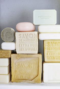 soaps are stacked on top of each other in different shapes and sizes, with one bar of soap next to it