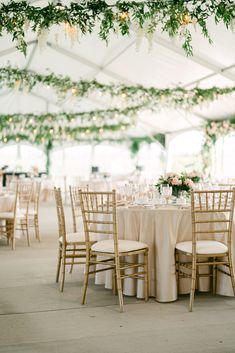 A hanging greenery installation transforms the Wedding Tent at Bella Terra Vineyard in Niagara-on-the-Lake Wedding Tent Garland, Wedding Ceiling Decorations Greenery, Indoor Wedding Reception Decorations Hanging Lights, Tent Wedding Greenery, Hanging Wisteria Wedding Tent, Wedding Reception Flowers Hanging, Simple Wedding Ceiling Decorations, Hanging Wedding Florals, Greenery On Ceiling